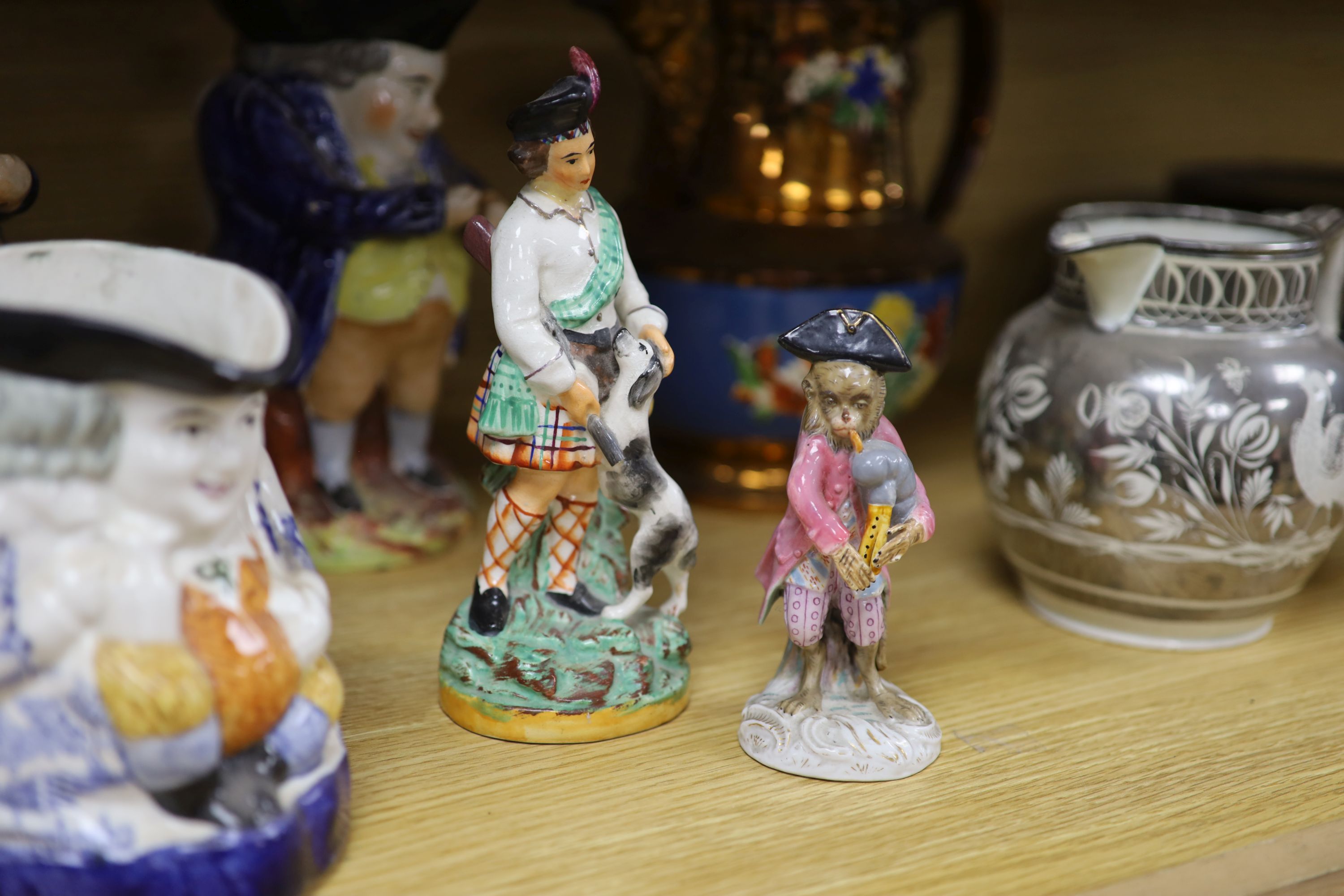 A quantity of Staffordshire pottery, including four Toby jugs, four figures, a copper lustre jug and a silver resist jug (10)